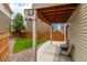 Enjoy serene outdoor living on the covered patio with a lush, green lawn at 10102 Yampa Ct, Commerce City, CO 80022
