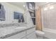 Well-lit bathroom featuring a granite countertop, stylish mirror and modern fixtures at 10102 Yampa Ct, Commerce City, CO 80022