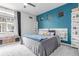 Bedroom with modern decor, a bright accent wall, and ample natural light at 10102 Yampa Ct, Commerce City, CO 80022