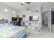 Spacious bedroom with two workspaces, large television, and comfortable bed at 10102 Yampa Ct, Commerce City, CO 80022
