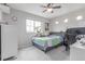 Inviting bedroom with large window, ceiling fan, and dedicated work space at 10102 Yampa Ct, Commerce City, CO 80022