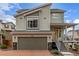 Inviting two-story home with a two-car garage, appealing architectural details, and a welcoming front porch at 10102 Yampa Ct, Commerce City, CO 80022