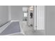 Bright hallway with changing table leading to a bathroom and bedroom at 10102 Yampa Ct, Commerce City, CO 80022