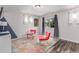 Inviting living room with hardwood floors, bright windows, and cozy seating at 10102 Yampa Ct, Commerce City, CO 80022