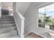 Carpeted staircase featuring a window with a view at 10102 Yampa Ct, Commerce City, CO 80022