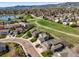 Stunning aerial view of a suburban neighborhood, showcasing lush greenery and a serene lake with mountain views at 11181 W Crestline Dr, Littleton, CO 80127
