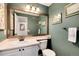 Powder room featuring painted walls, framed art, and mirror with bronze accents at 11181 W Crestline Dr, Littleton, CO 80127