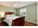 Bedroom with hardwood floors, natural light, and a wooden bed frame at 11181 W Crestline Dr, Littleton, CO 80127