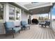 View of the outdoor deck with patio furniture, BBQ and string lights, great for entertaining at 11181 W Crestline Dr, Littleton, CO 80127