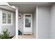 Inviting home entrance featuring a white door, charming address plate, and stylish accents at 11181 W Crestline Dr, Littleton, CO 80127
