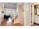 Inviting entryway with wood floors, staircase, and access to a bathroom and living area at 11181 W Crestline Dr, Littleton, CO 80127