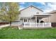 Back exterior view of the two-story home with a deck and fenced yard at 11181 W Crestline Dr, Littleton, CO 80127