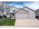 Charming two-story home featuring a three-car garage, well-maintained lawn, and inviting curb appeal at 11181 W Crestline Dr, Littleton, CO 80127