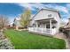 Exterior view of home showcasing the backyard with a spacious lawn at 11181 W Crestline Dr, Littleton, CO 80127