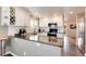 Well-appointed kitchen with stainless steel appliances, granite counters, and a wine rack at 11181 W Crestline Dr, Littleton, CO 80127