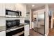 Modern kitchen with stainless steel appliances, granite countertops, and tile flooring at 11181 W Crestline Dr, Littleton, CO 80127