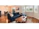 Cozy living room boasts hardwood floors, modern furniture, and bright windows with plantation shutters at 11181 W Crestline Dr, Littleton, CO 80127