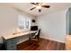 Home office with hardwood floors, built-in desk and natural light at 11181 W Crestline Dr, Littleton, CO 80127