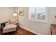 Sitting area with hardwood floors, chair with ottoman and natural light at 11181 W Crestline Dr, Littleton, CO 80127