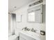Clean bathroom with gray vanity and mirrored medicine cabinet at 12470 E Cornell Ave # 104, Aurora, CO 80014