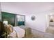 Serene bedroom featuring green accent wall, window, neutral tones, and plenty of space at 12470 E Cornell Ave # 104, Aurora, CO 80014