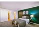 Green-walled bedroom with ensuite bathroom access at 12470 E Cornell Ave # 104, Aurora, CO 80014