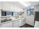 Clean kitchen featuring white cabinets and modern appliances at 12470 E Cornell Ave # 104, Aurora, CO 80014