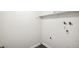 Small laundry room with hookups and shelving at 12470 E Cornell Ave # 104, Aurora, CO 80014