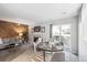Cozy living room features a wooden accent wall, fireplace, comfortable seating, and a sliding glass door at 12470 E Cornell Ave # 104, Aurora, CO 80014