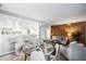 Inviting living space features a dining area, modern decor, and wood accent wall at 12470 E Cornell Ave # 104, Aurora, CO 80014