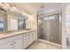 Bathroom features a double vanity, large mirror, and a glass-enclosed shower at 2616 Loon Cir, Castle Rock, CO 80104