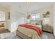 Well-lit bedroom features a bed with a salmon blanket, side tables, and decorations at 2616 Loon Cir, Castle Rock, CO 80104