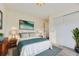 Bright bedroom features a bed with a teal blanket, a large window, and neutral colors at 2616 Loon Cir, Castle Rock, CO 80104