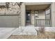 Inviting front porch and two-car garage showcasing stone accents and well-manicured landscaping at 2616 Loon Cir, Castle Rock, CO 80104