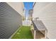 Backyard area with artificial turf, dog house, and privacy fence between homes at 18211 E 51St Ave, Denver, CO 80249