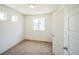 Bright bedroom featuring neutral carpet, white walls, and ample natural light from windows at 18211 E 51St Ave, Denver, CO 80249