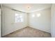 Sunlit bedroom with neutral tones and carpet, complete with built-in closet at 18211 E 51St Ave, Denver, CO 80249