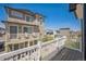 Exterior view from deck showcasing home's facade and neighborhood at 18211 E 51St Ave, Denver, CO 80249