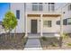 Inviting three-story home featuring a light exterior, well-kept yard, and welcoming architectural design at 18211 E 51St Ave, Denver, CO 80249