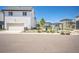 View of a modern home exterior and park area with picnic tables and shelters on a beautiful day at 18211 E 51St Ave, Denver, CO 80249