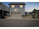Charming two-story home with a garage, rock landscaping, and neatly kept lawn at 18211 E 51St Ave, Denver, CO 80249