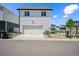 View of the two-story home with a garage, rock landscaping, and manicured lawn at 18211 E 51St Ave, Denver, CO 80249