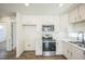 Modern kitchen with stainless steel appliances, light countertops, and white cabinetry at 18211 E 51St Ave, Denver, CO 80249