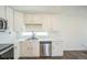 Well-lit kitchen showcasing white cabinets, stainless steel appliances, and contemporary countertops at 18211 E 51St Ave, Denver, CO 80249