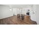 Open-concept living area featuring wood floors, neutral walls, and natural light at 18211 E 51St Ave, Denver, CO 80249