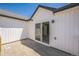 Outdoor patio space featuring a sliding glass door, white siding, and wood-look flooring at 18211 E 51St Ave, Denver, CO 80249
