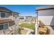 View from deck overlooking green space, benches, and adjacent modern homes at 18211 E 51St Ave, Denver, CO 80249