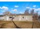 View of home exterior featuring a backyard and mature tree with grassy area at 3299 S Forest St, Denver, CO 80222