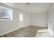 Bright bedroom with modern flooring, a window, and a door leading outside at 3299 S Forest St, Denver, CO 80222