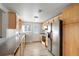 Bright kitchen featuring stainless steel appliances, wood cabinets, and light wood flooring at 3299 S Forest St, Denver, CO 80222